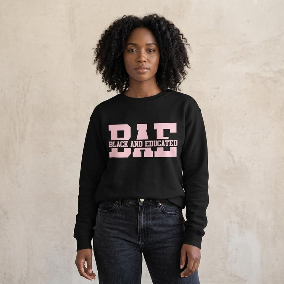 Woman wearing a black Black and Educated crewneck sweatshirt