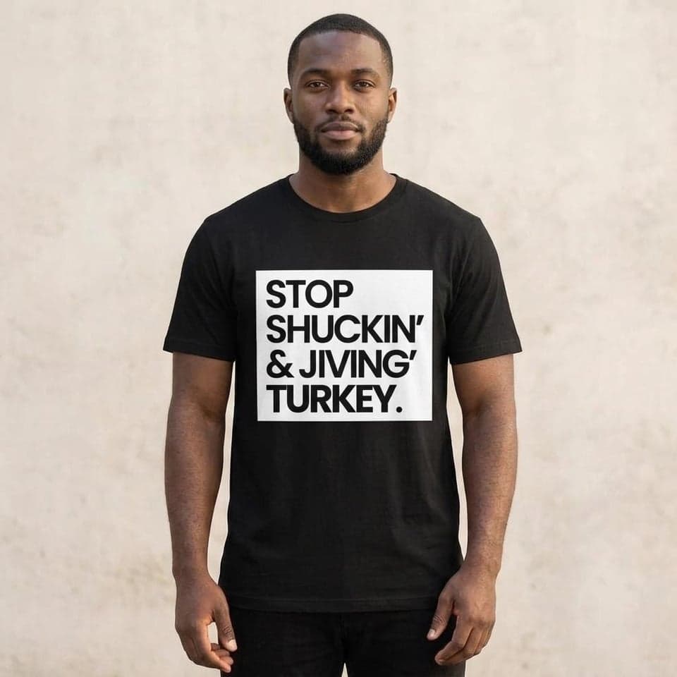 Man wearing the black Stop Shuckin & Jiving graphic T-shirt